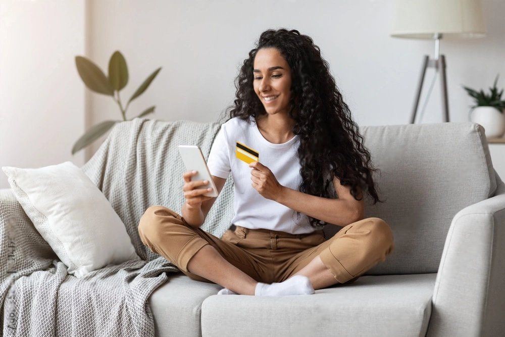 Girl smiling while shopping online | Coral Spring Med Spa | Coral Springs, FL